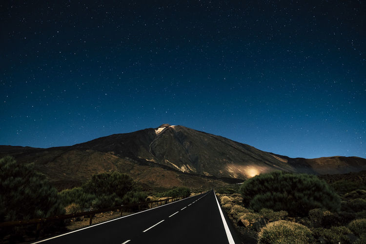 Scenic view of mountains against clear sky at night