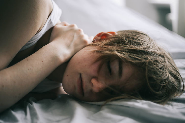 Close-up of young woman sleeping on bed