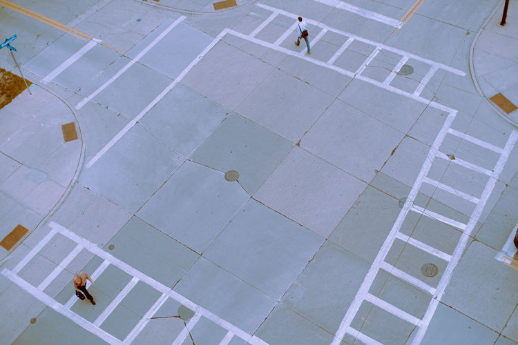 High angle view of people walking on footpath in city