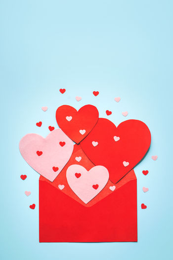 Close-up of red heart shape against blue background