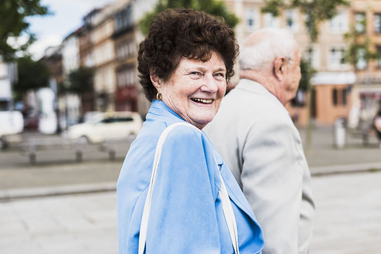 Portrait of senior woman strolling with her husband