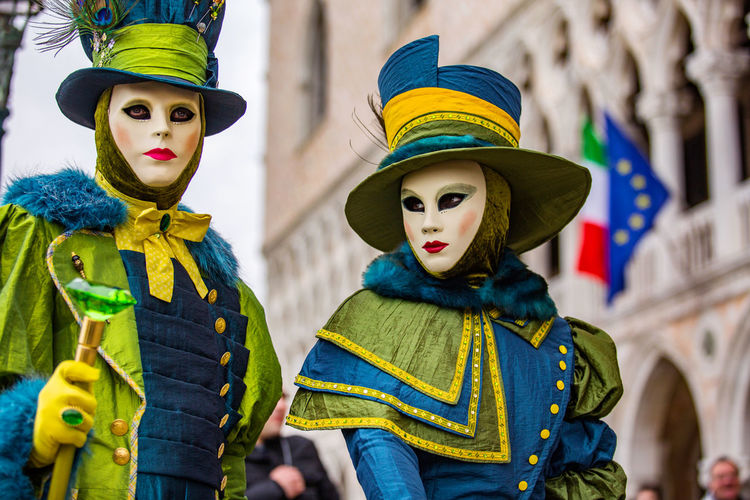 Man and woman in costume during venice carnival