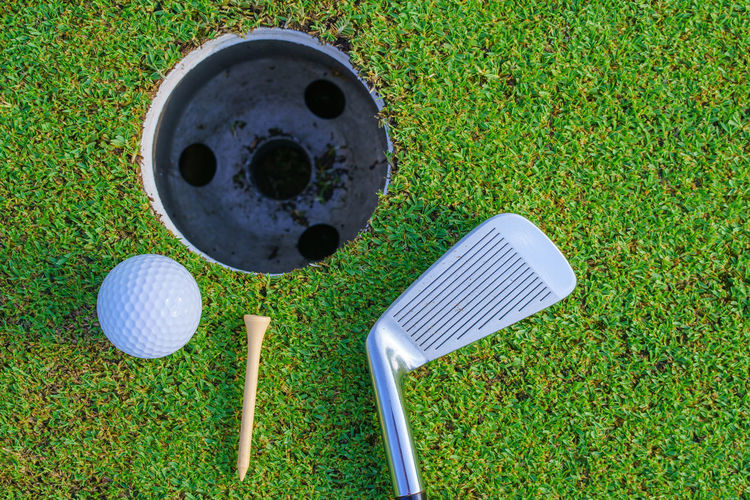 High angle view of golf equipment on grassy field