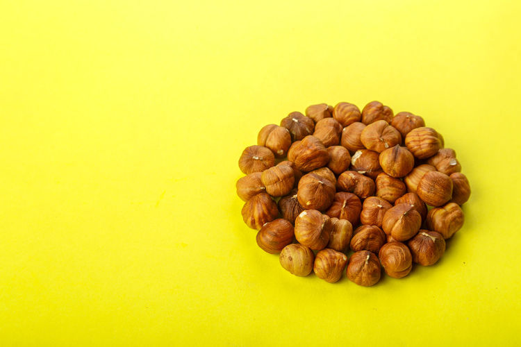 Close-up of coffee beans against yellow background