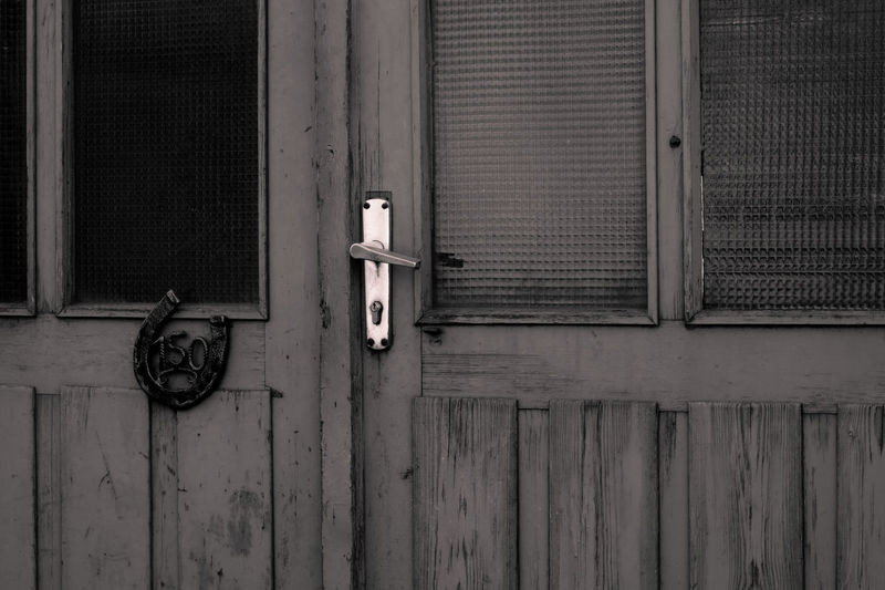 Closed wooden door of old house