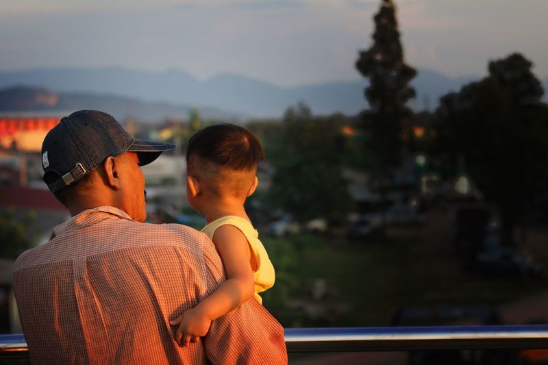 Rear view of father carrying son