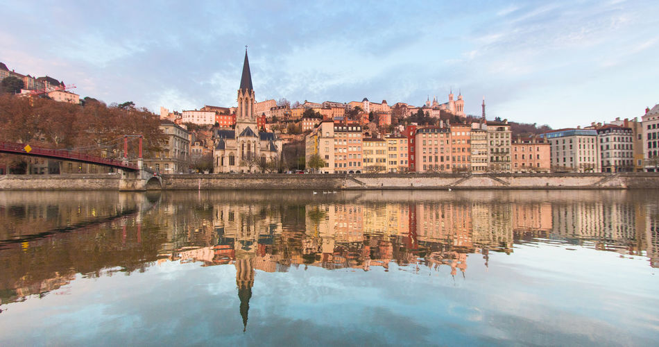 Old lyon and the saint-georges district seen from the edge of the saône at dawn