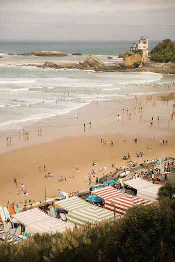 Overlooking a beach full of surfers in biarritz, france