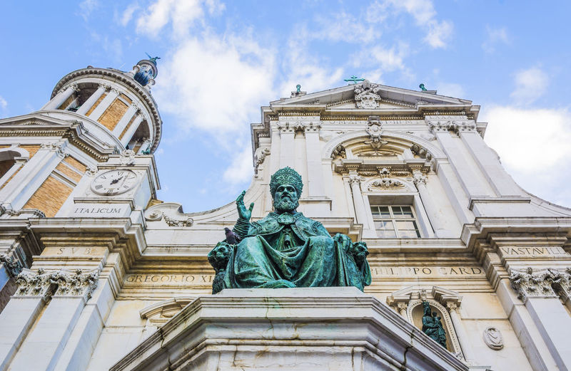Low angle view of statue against cathedral
