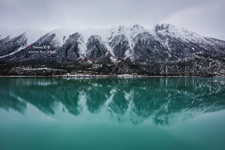 Scenic view of lake against cloudy sky