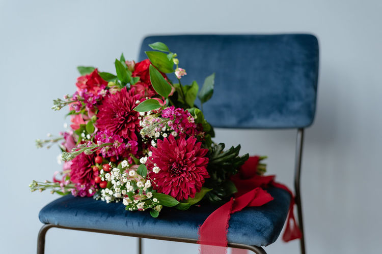 Close-up of flowers on table against wall