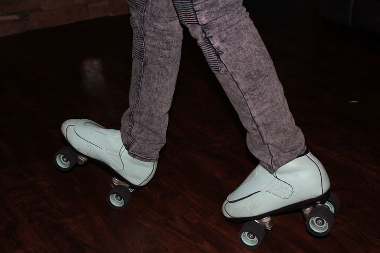 Low section of person roller skating