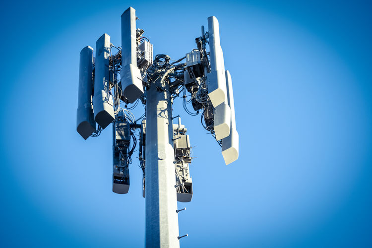 Low angle view of camera against blue sky