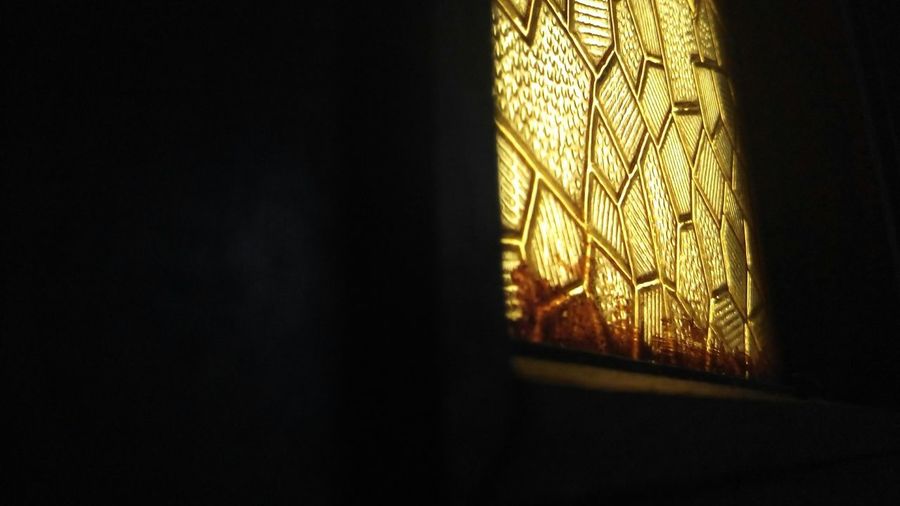Close-up of illuminated window in dark room
