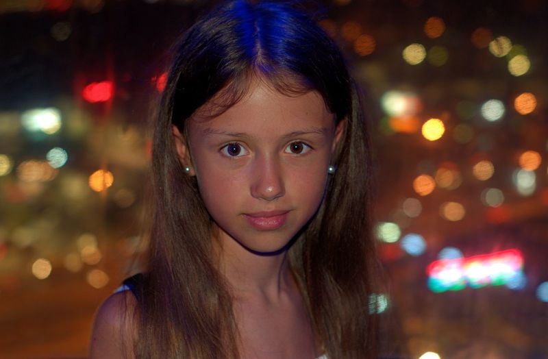 Portrait of smiling girl at night