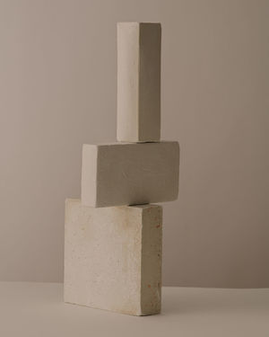 Close-up of stone stack on table against white background