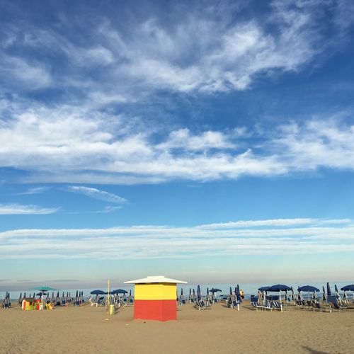 Scenic view of beach against blue sky