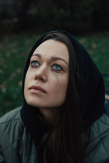 Portrait of crying young woman on the street