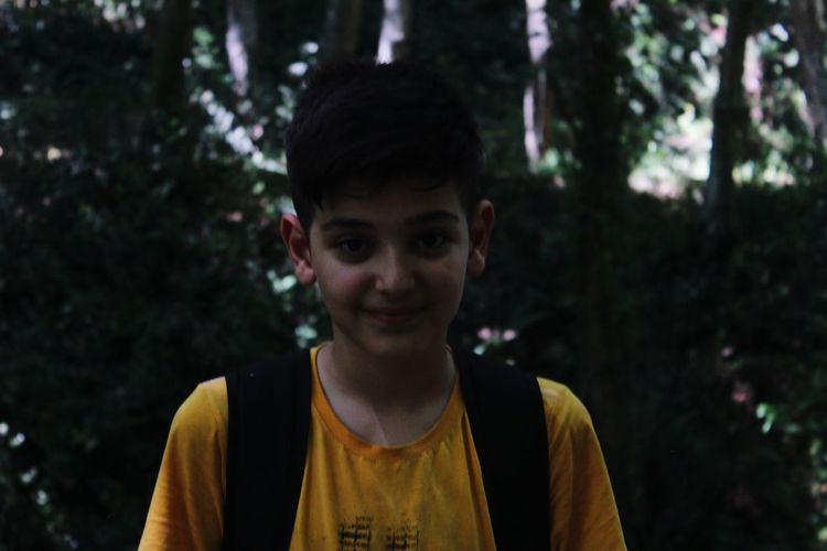 Portrait of smiling boy in forest