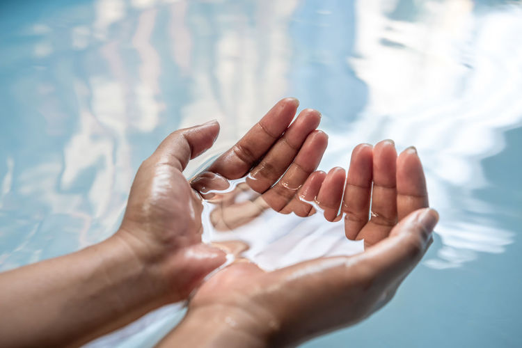 Cupped hands of woman in water