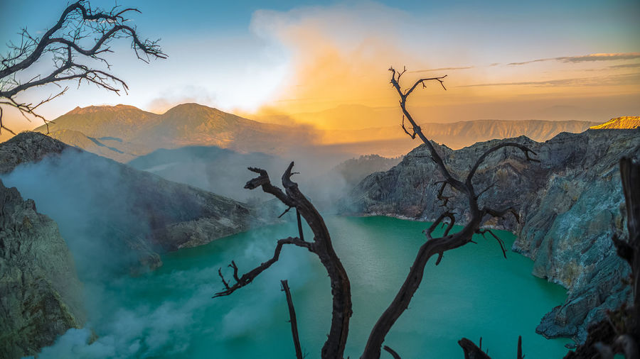 Scenic view of mountains against sky during sunrise at ijen lake crater volcano. 