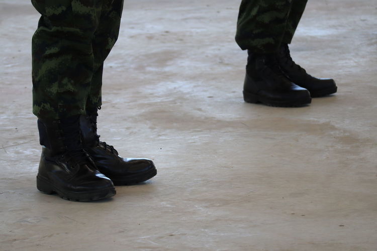 Low section of soldiers walking on floor