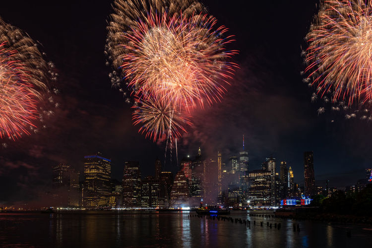 Firework display in city at night