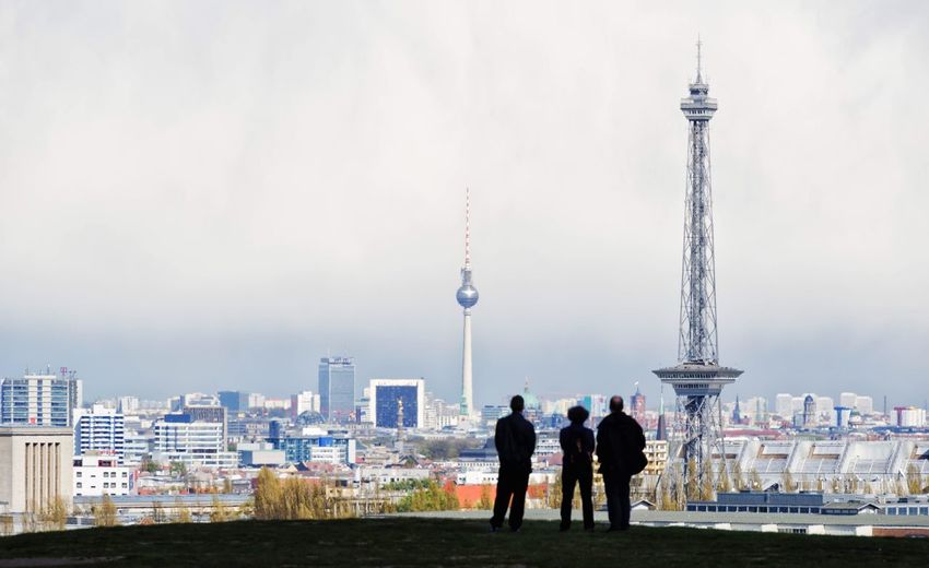 Rear view of people overlooking cityscape