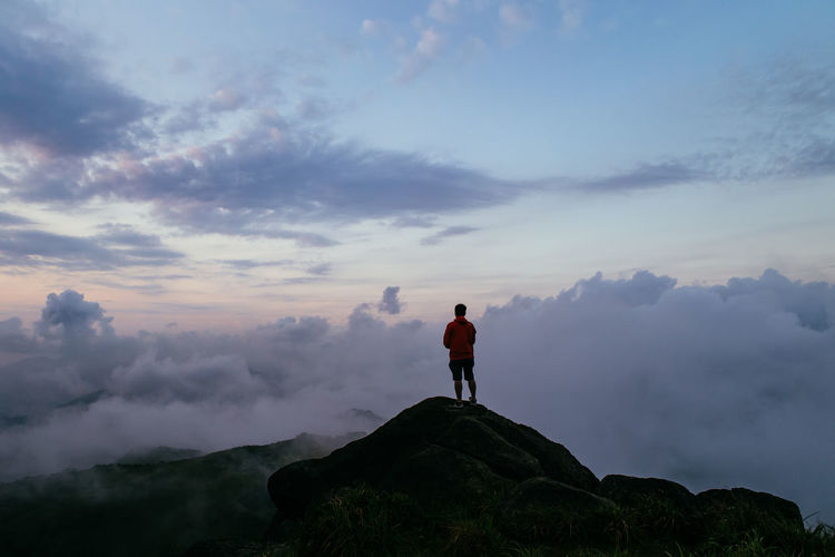 Silhouette man overlooking scenic cloudscape