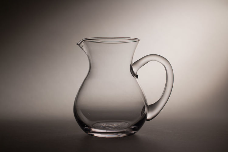 Close-up of empty jug against gray background