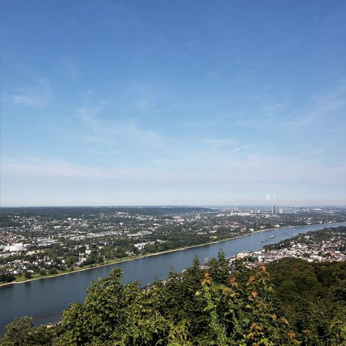 High angle view of sea and cityscape against sky