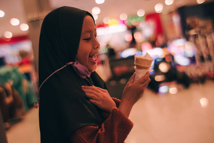 Young woman holding ice cream