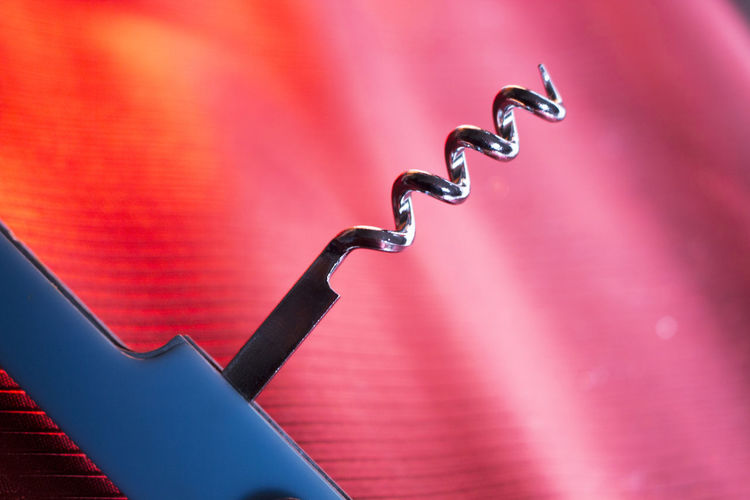 Close-up of corkscrew against illuminated background