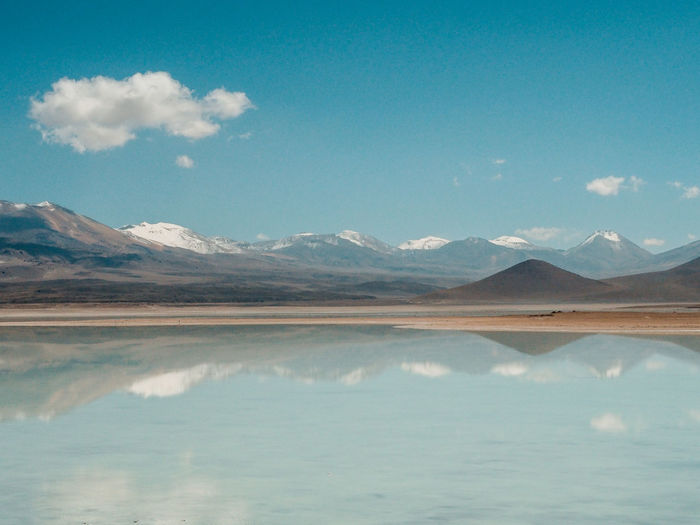 Scenic view of lake and mountains against sky