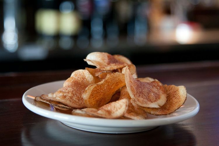 Potato chips served on plate