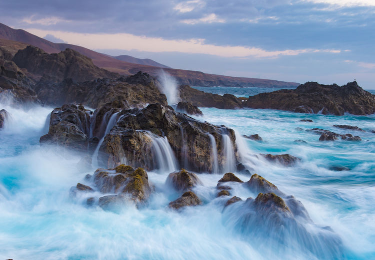 Scenic view of sea against cloudy sky