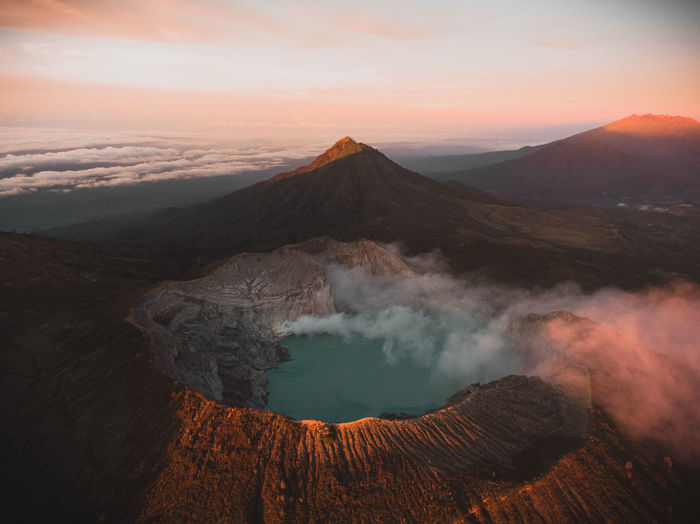 Volcanic landscape against sky during sunset