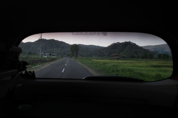 Road seen through rear windshield
