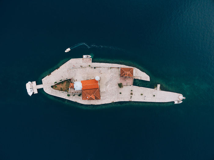 High angle view of boat in sea against building