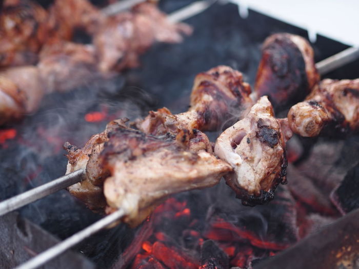Fragrant smoke and steam from delicious fried chicken pieces on skewers. winter shish kebab fried 