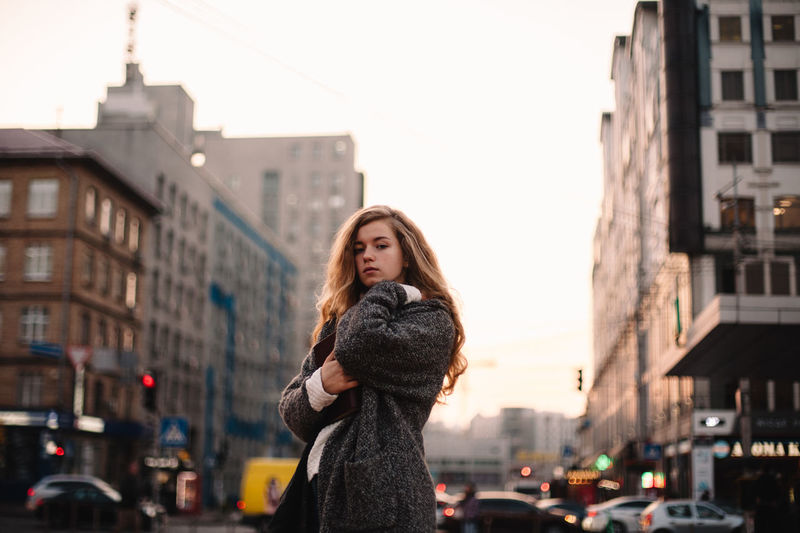 Portrait of woman standing in city
