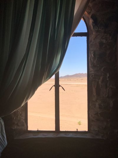 Scenic view of landscape seen through window
