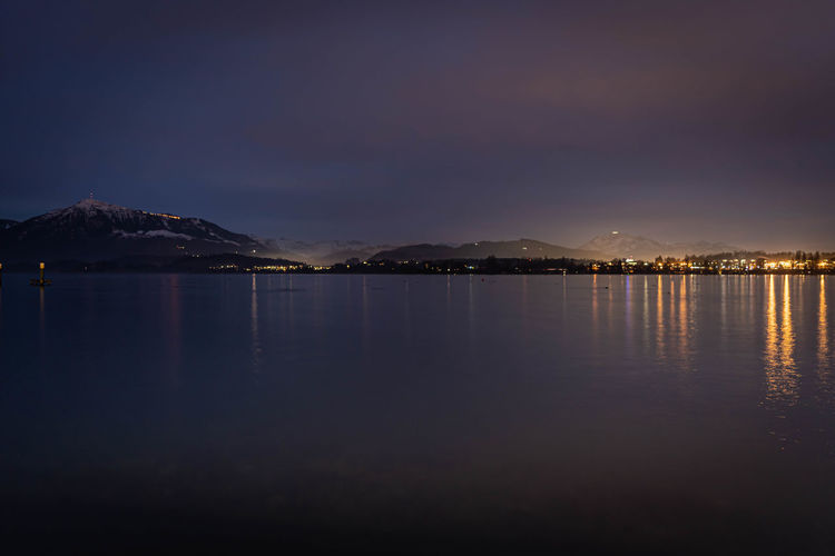 Scenic view of sea against sky at night lake of zug with rigi and pilatus 
