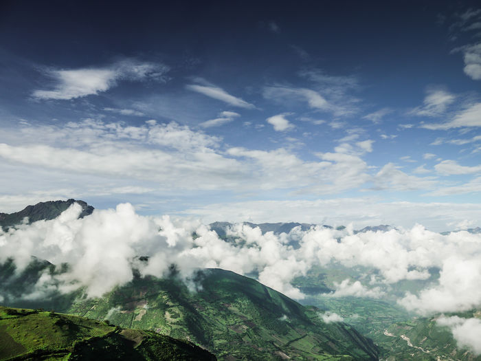 Scenic view of clouds over landscape against sky