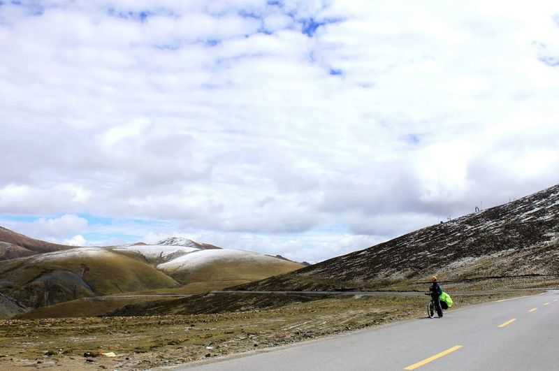 Man on road against sky