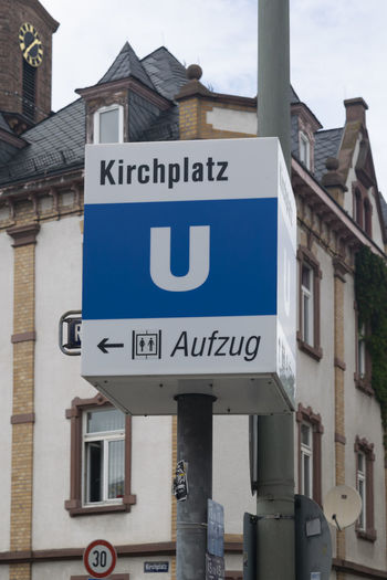 Road sign by building in city
