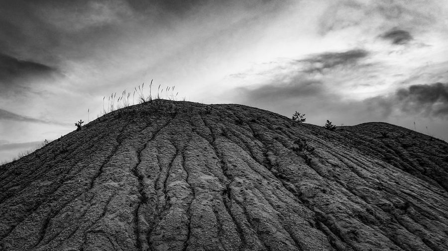Low angle view of rocks on land against sky