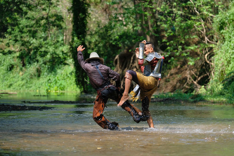 Men fighting in river