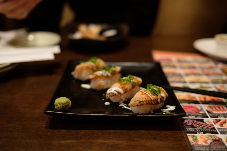 Close-up of sushi served on wooden table