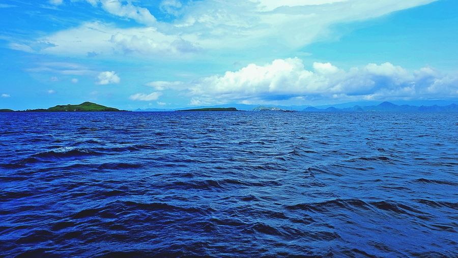 Scenic view of sea against cloudy sky